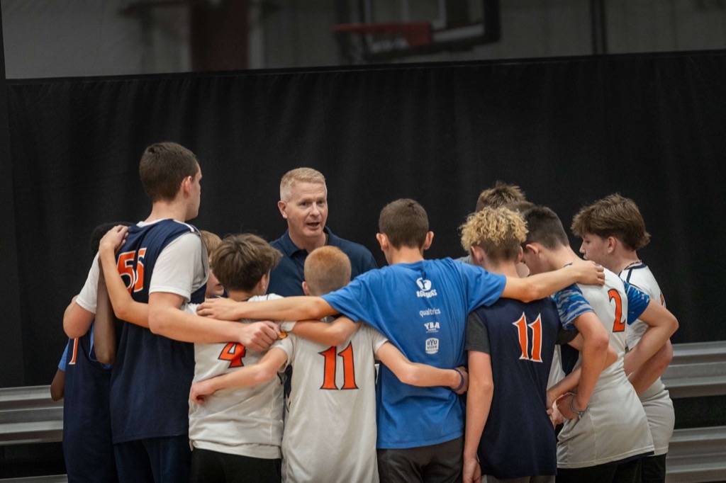 Coach Ricky Bower addresses Idaho Stags players in a team huddle